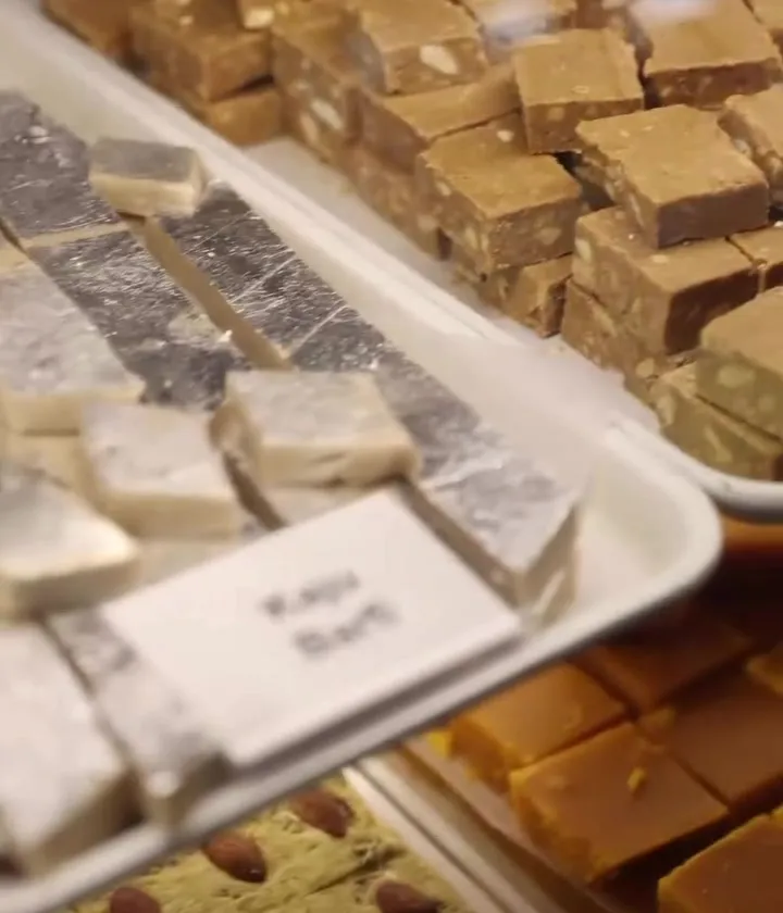 Trays of barfi, including kaju barfi, in the A1 Sweets counter
